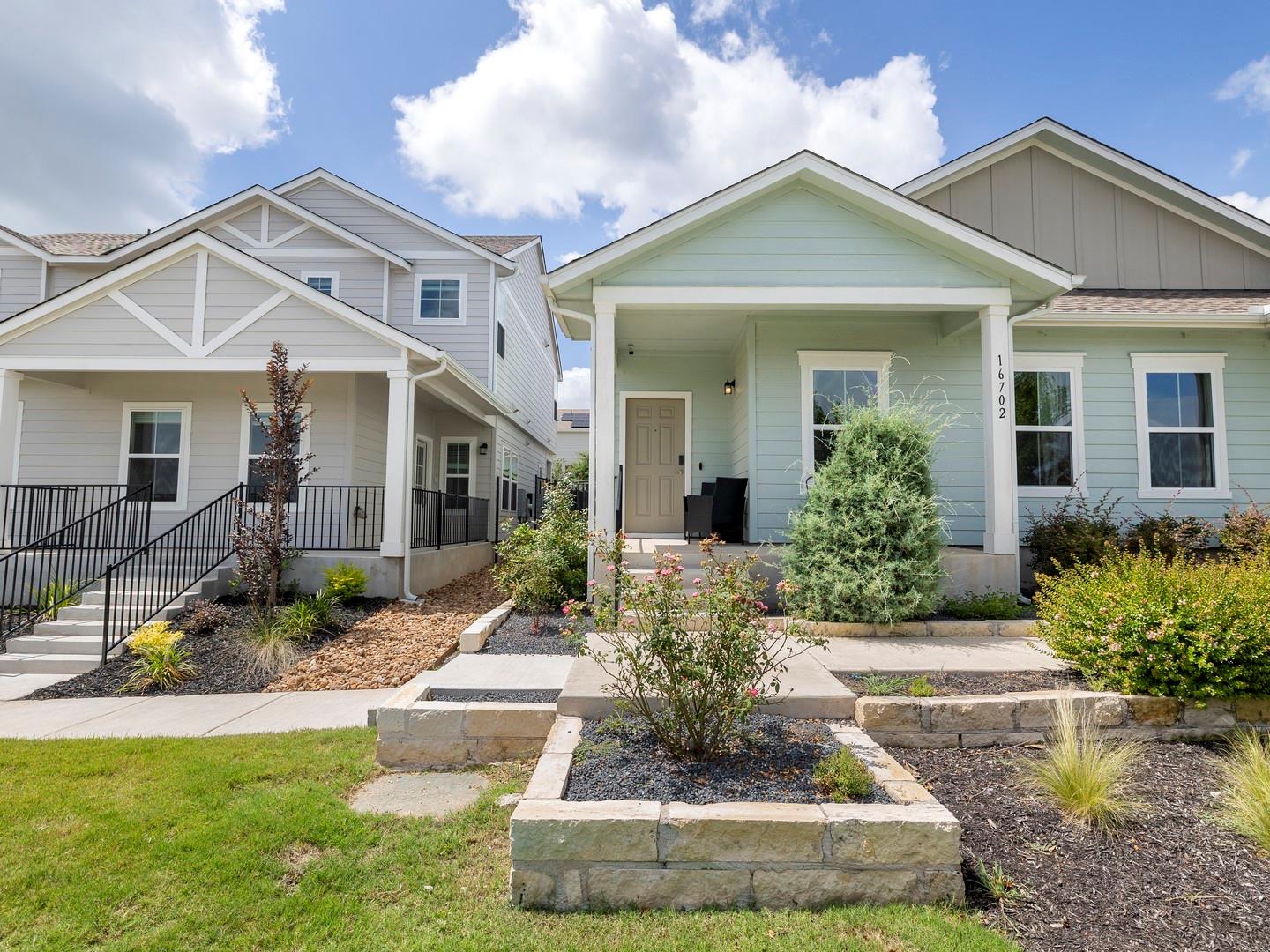 A welcoming facade showcases crisp siding and tho