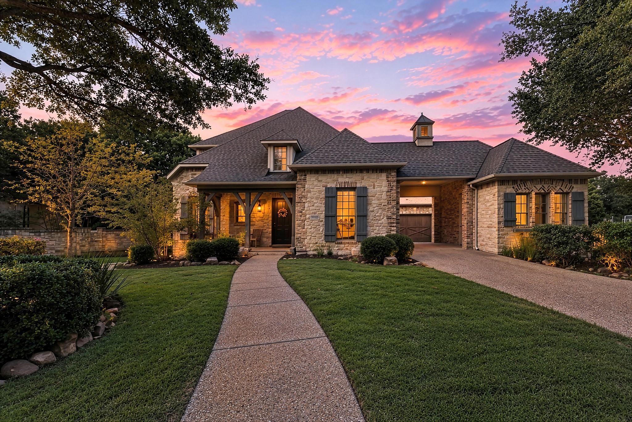 A stone facade and paved walkway lead to this ele