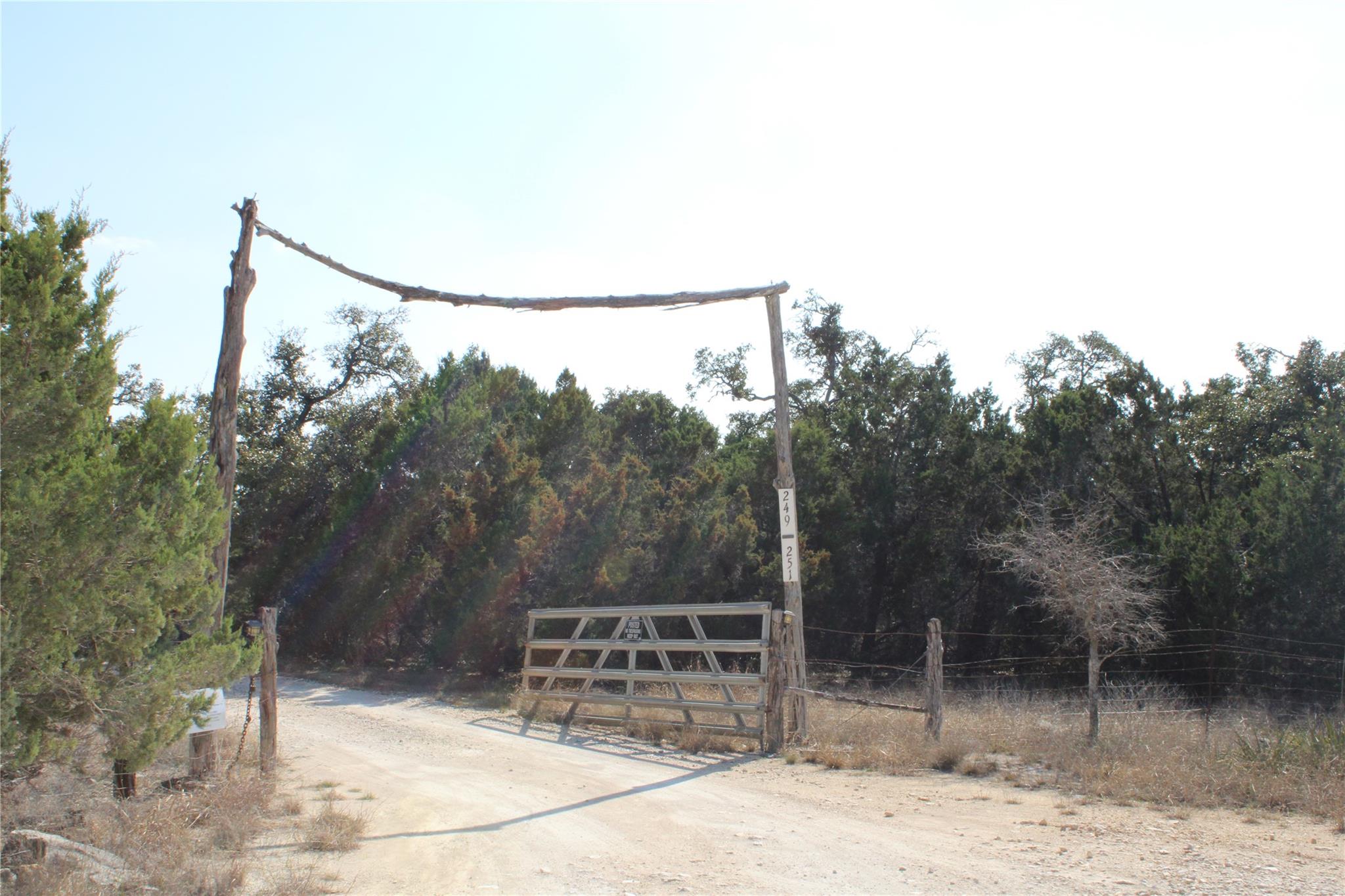 View of dirt / gravel road with a gate