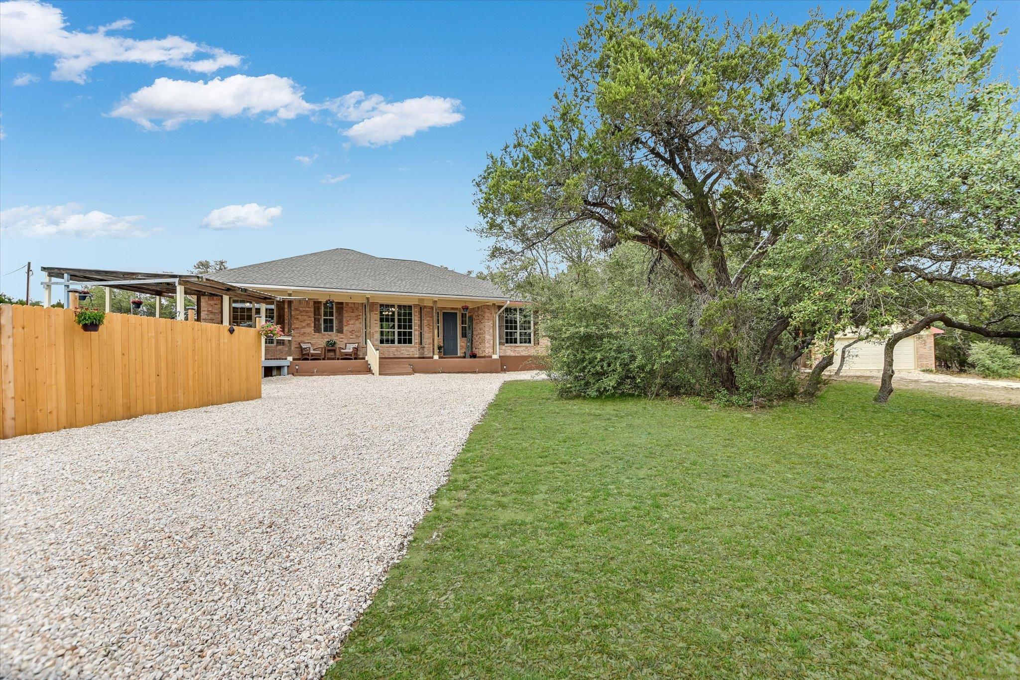 Rear view of house with brick siding, a deck, and
