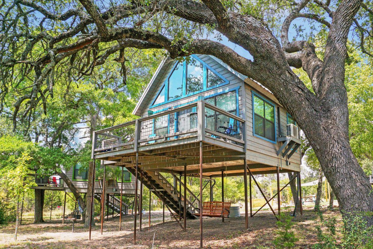 Rear view of property featuring a wooden deck and