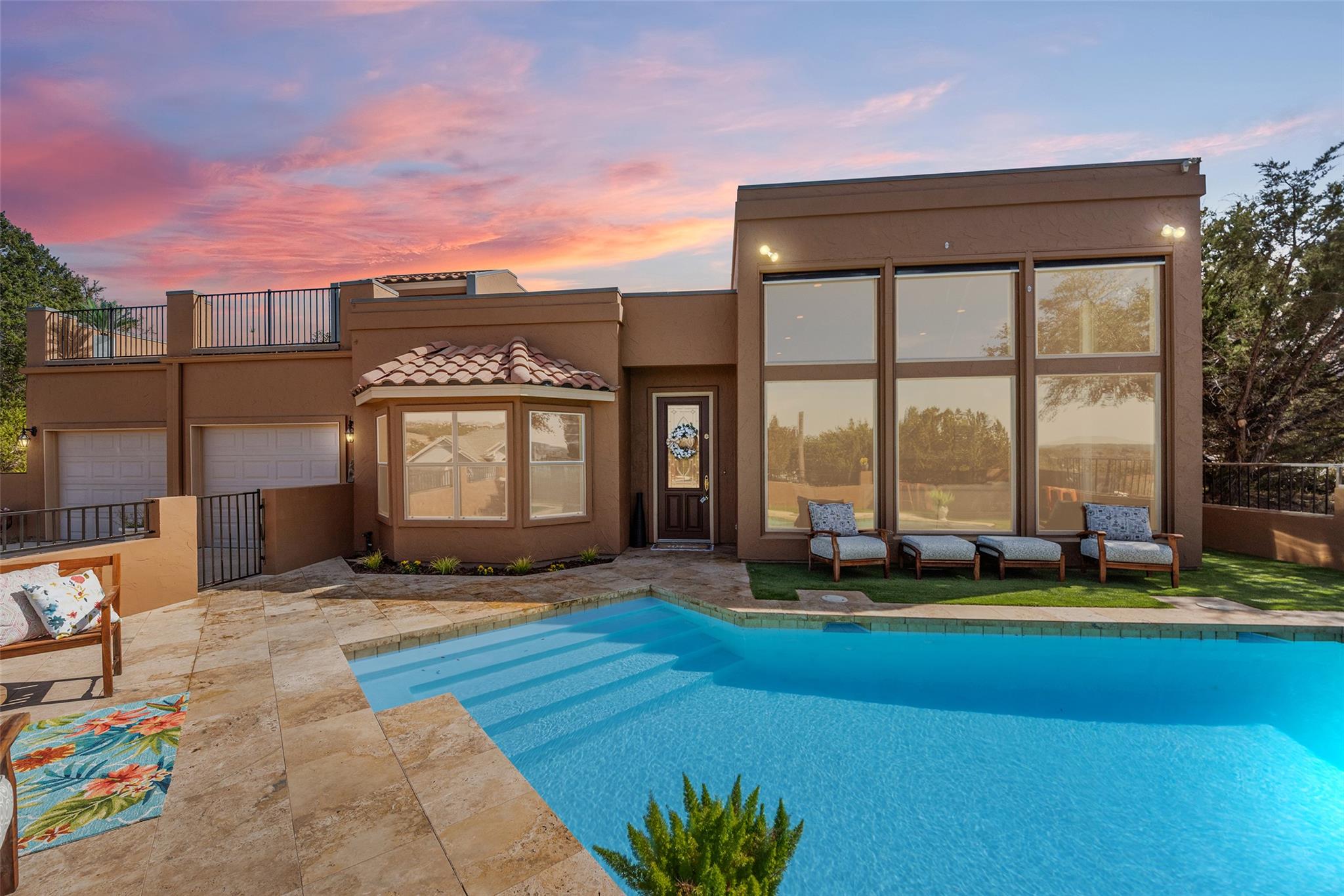 Back of house featuring an outdoor pool, stucco s