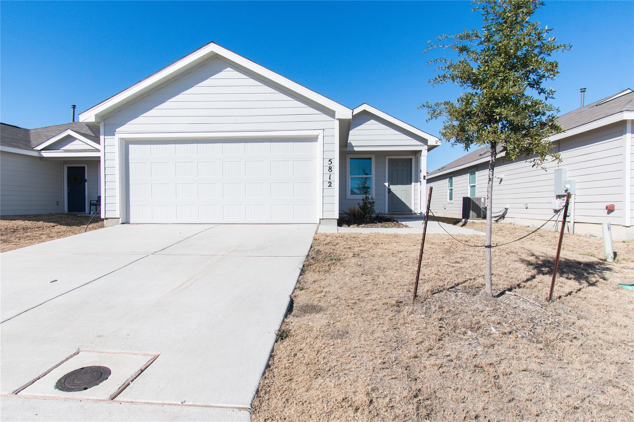 Ranch-style home with driveway and a garage