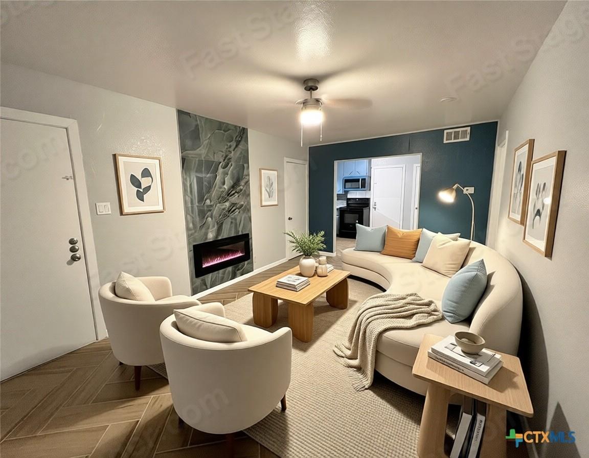 Living room featuring a high end fireplace and a 