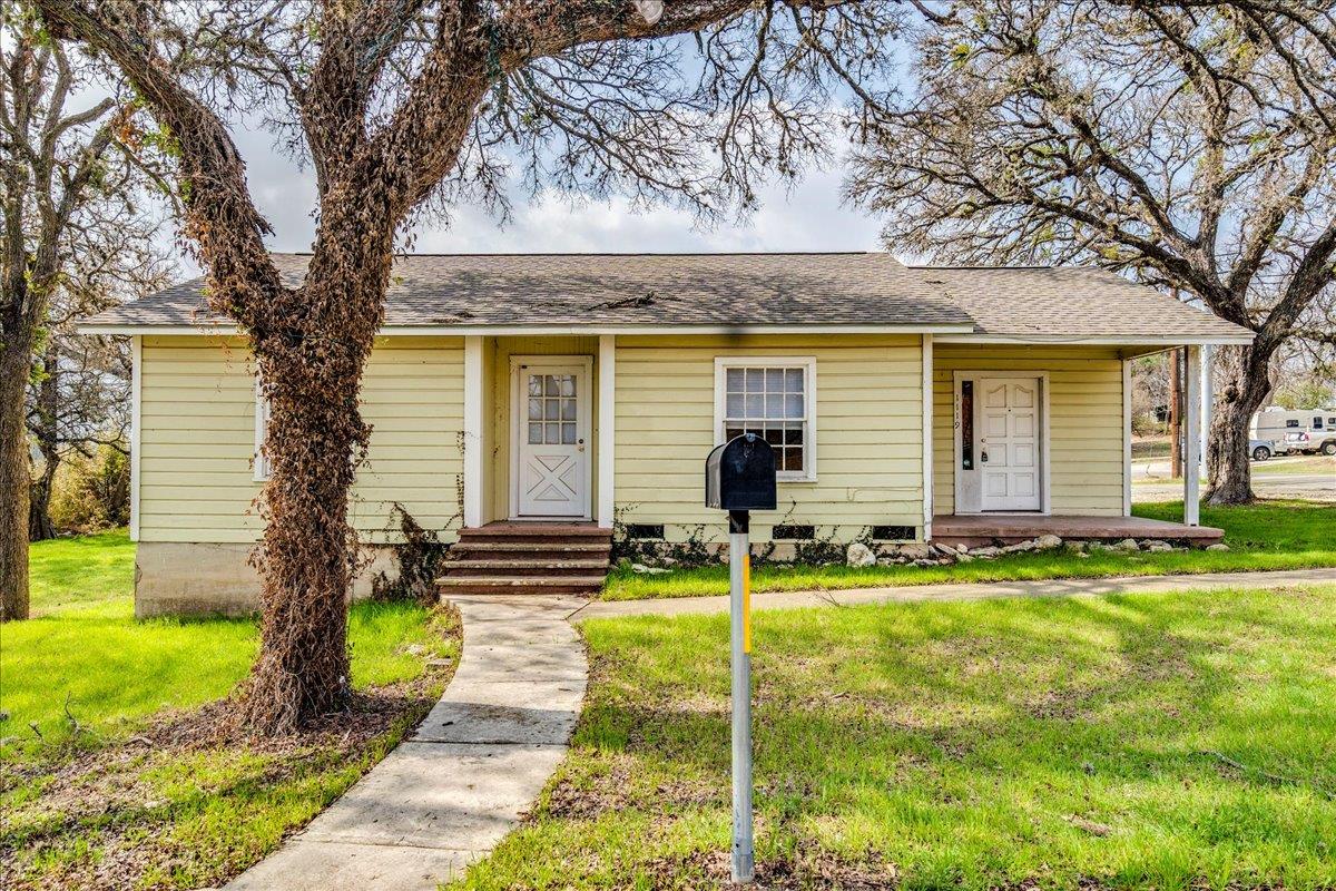 View of front of property with a front yard and r