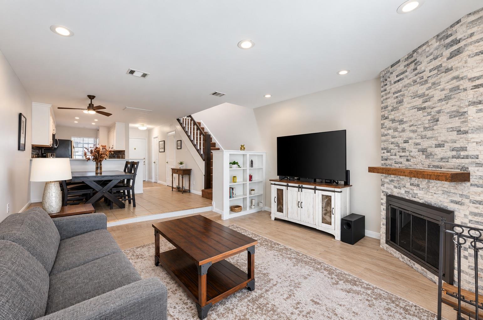 Kitchen featuring white cabinets, light stone cou