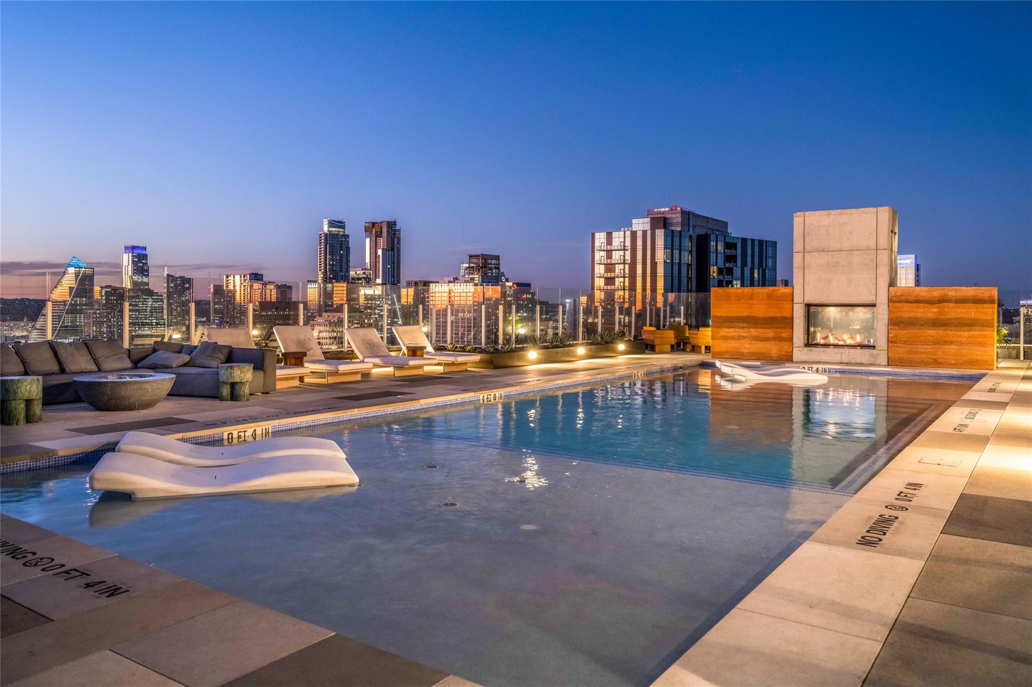 Pool at dusk with a patio area, a community pool,