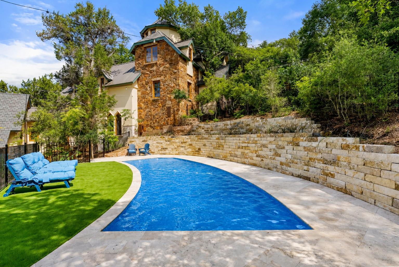 A private swimming pool with curved edges awaits 
