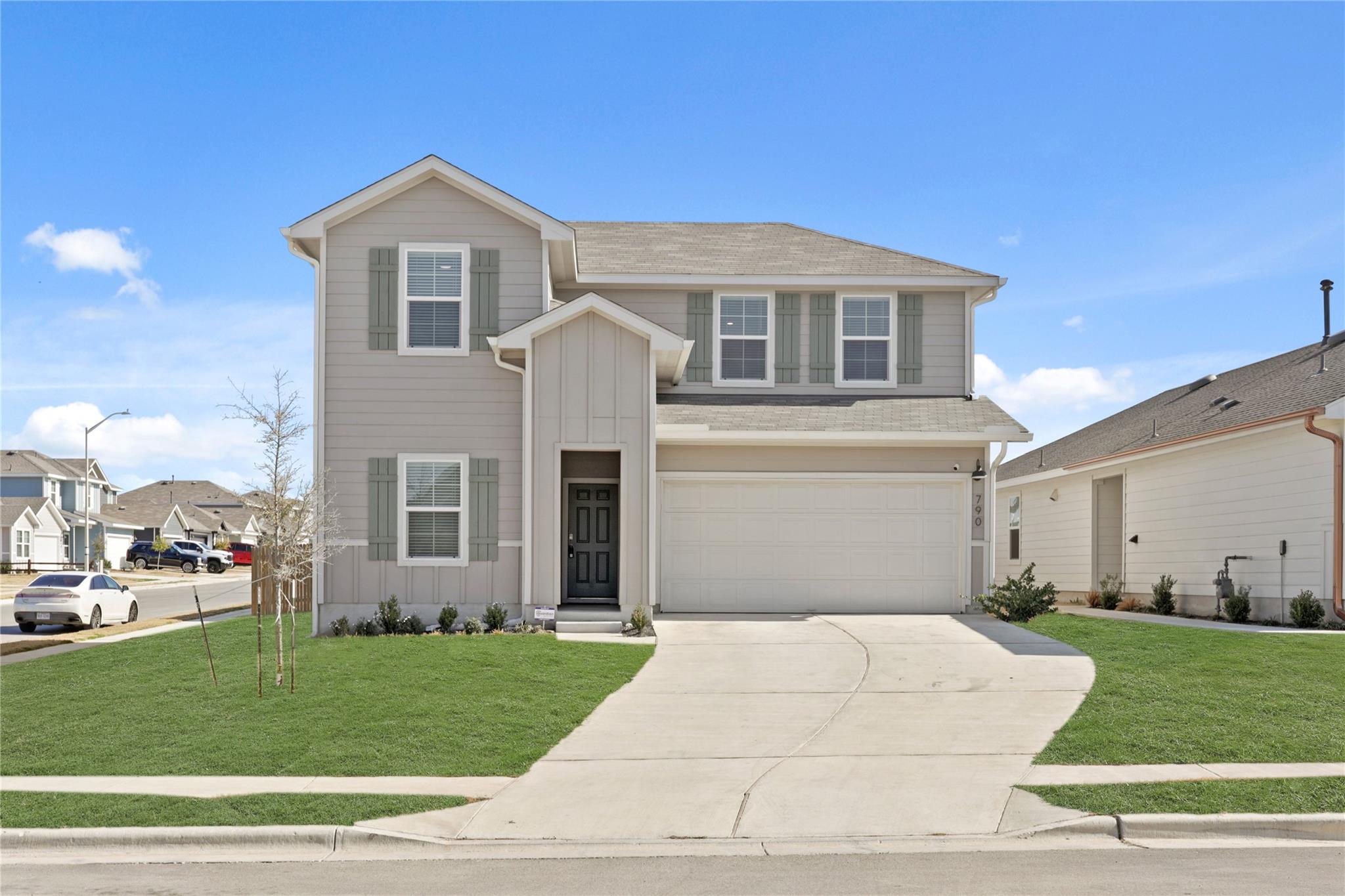 Traditional-style home featuring a garage, a fron