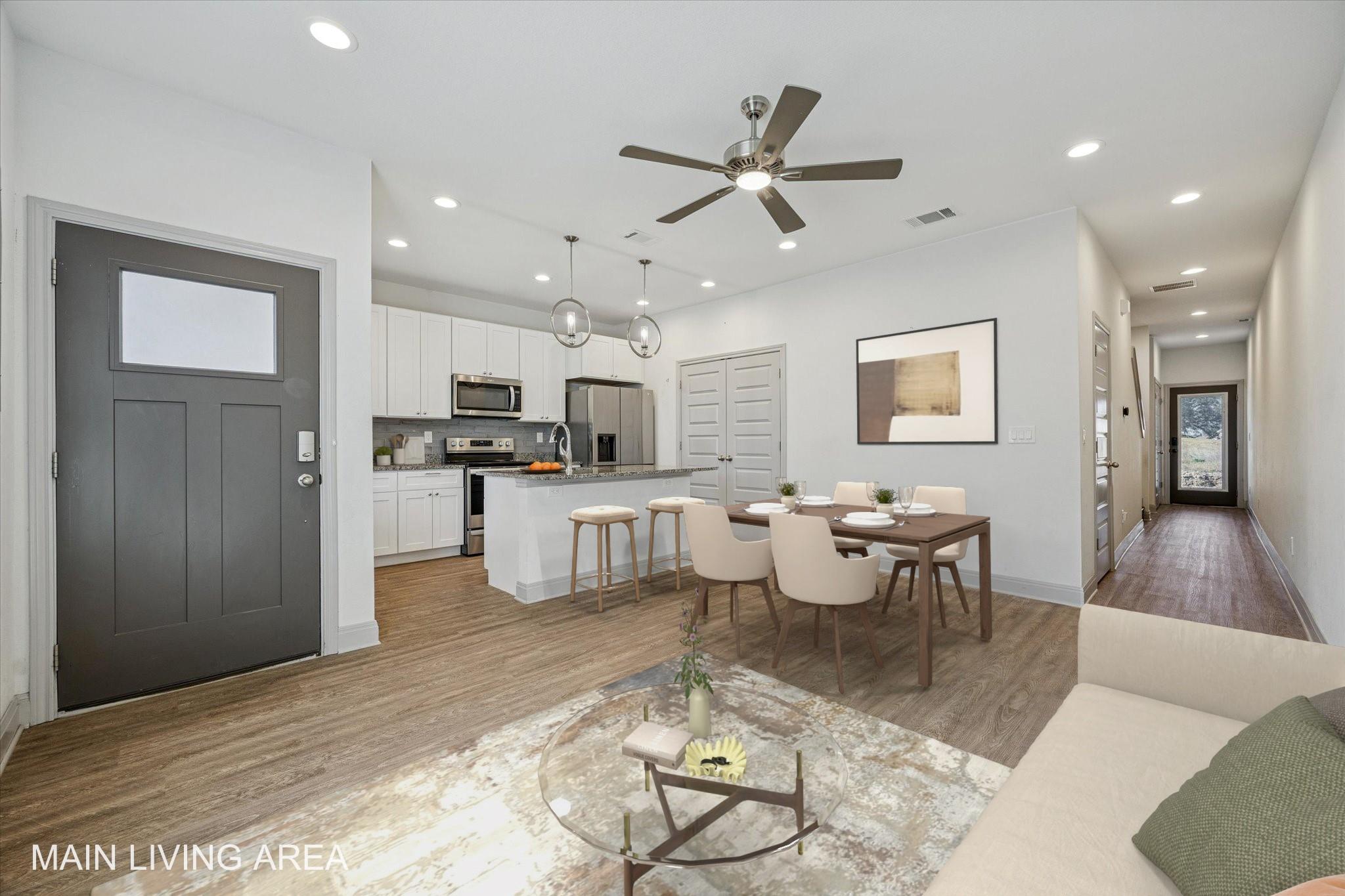 Open concept living area featuring wood-finish fl
