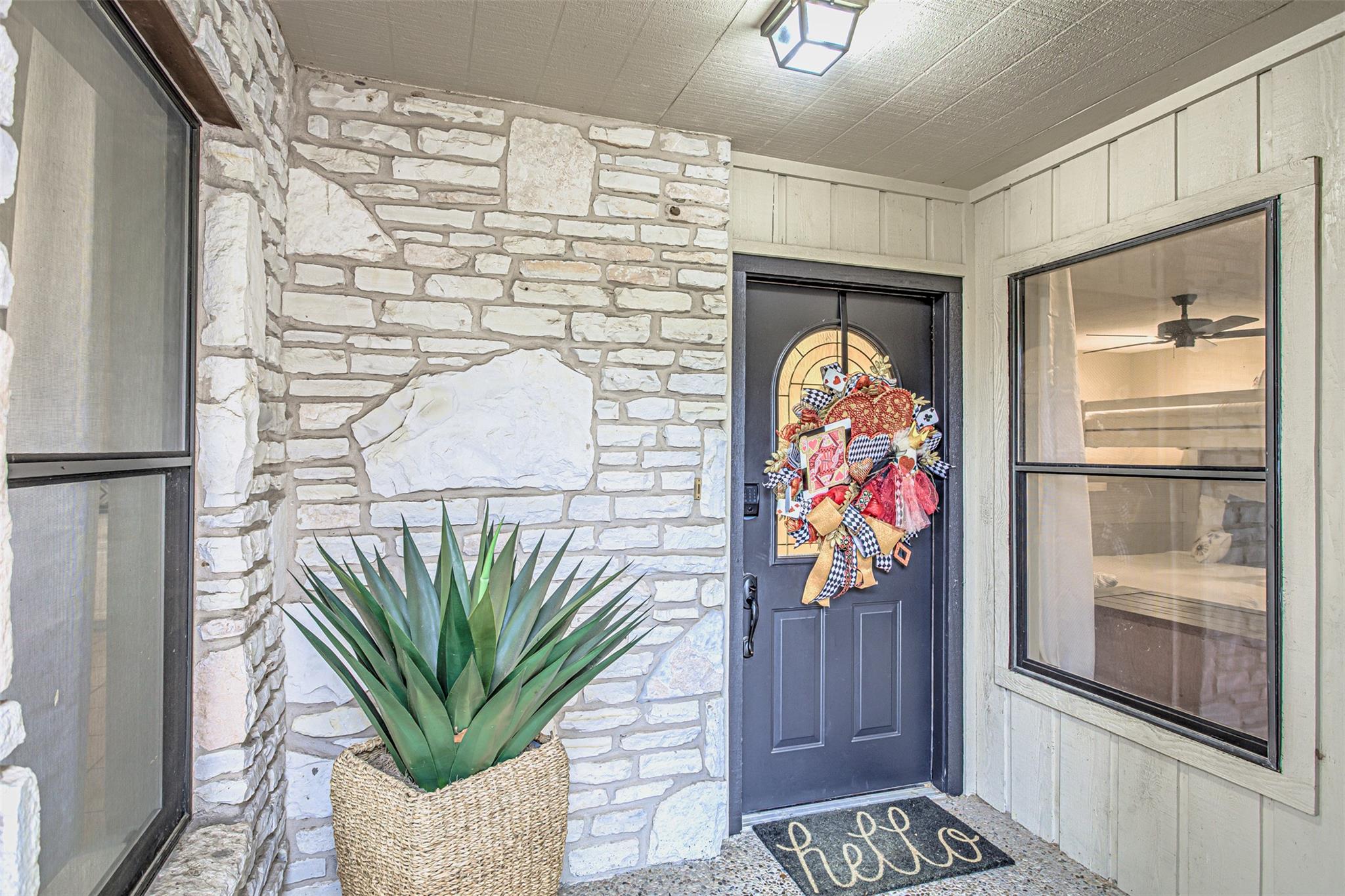 Entrance to property with stone siding
