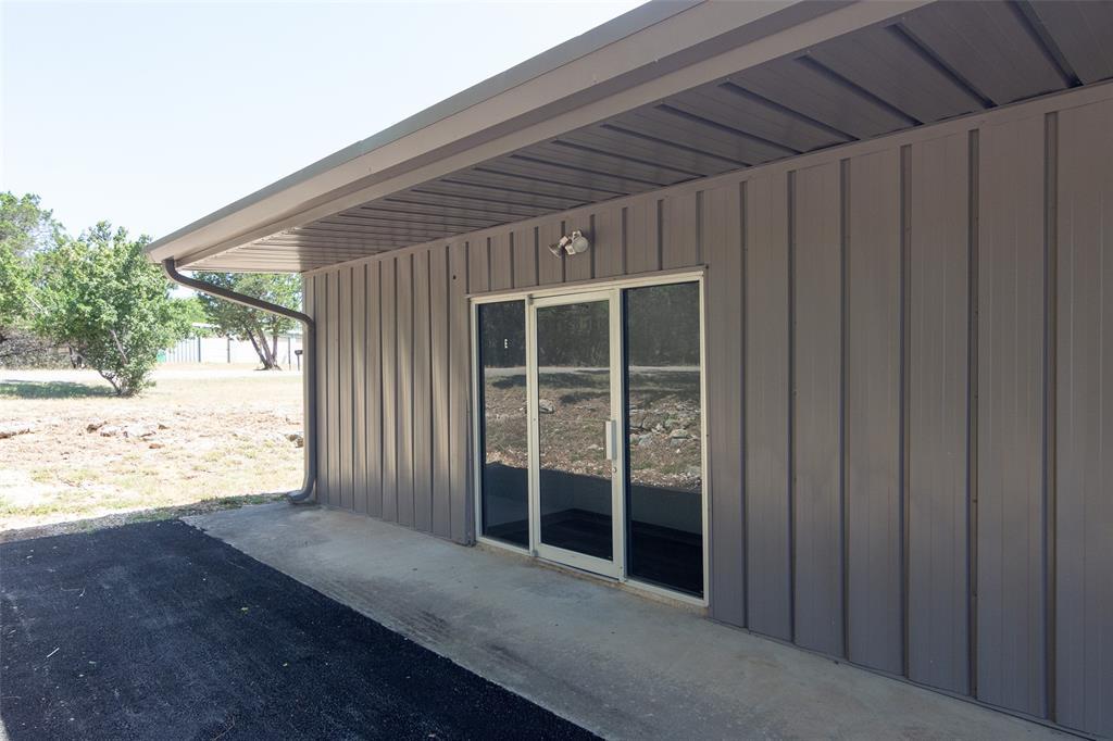 Doorway to property featuring a patio and board a