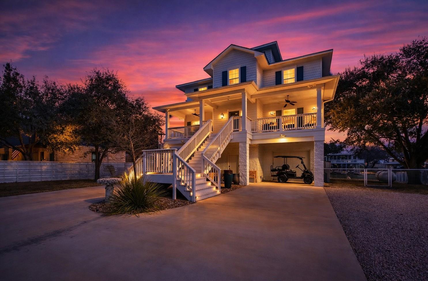 Raised beach house featuring ceiling fan, concret