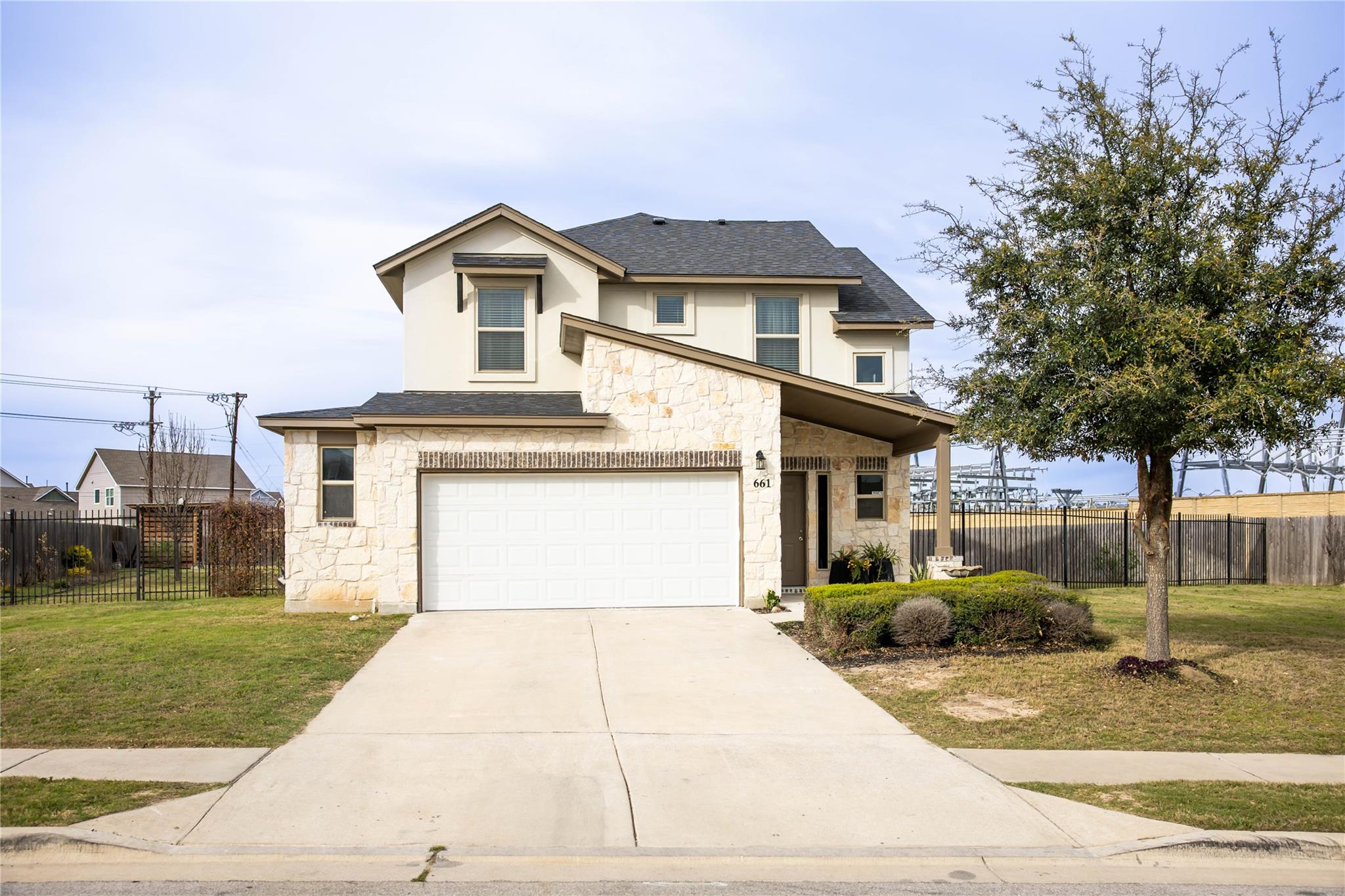 Traditional-style home featuring stone siding, dr