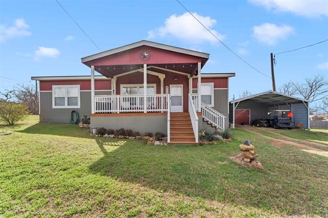 Bungalow-style home with a porch, a carport, and 