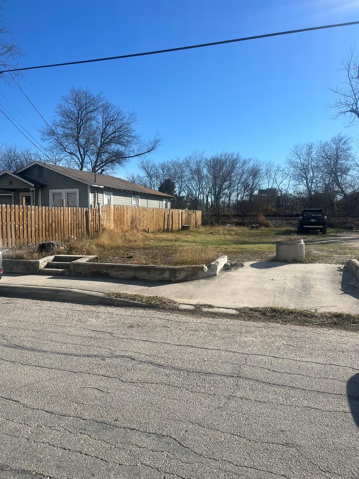 View of asphalt street featuring curbs