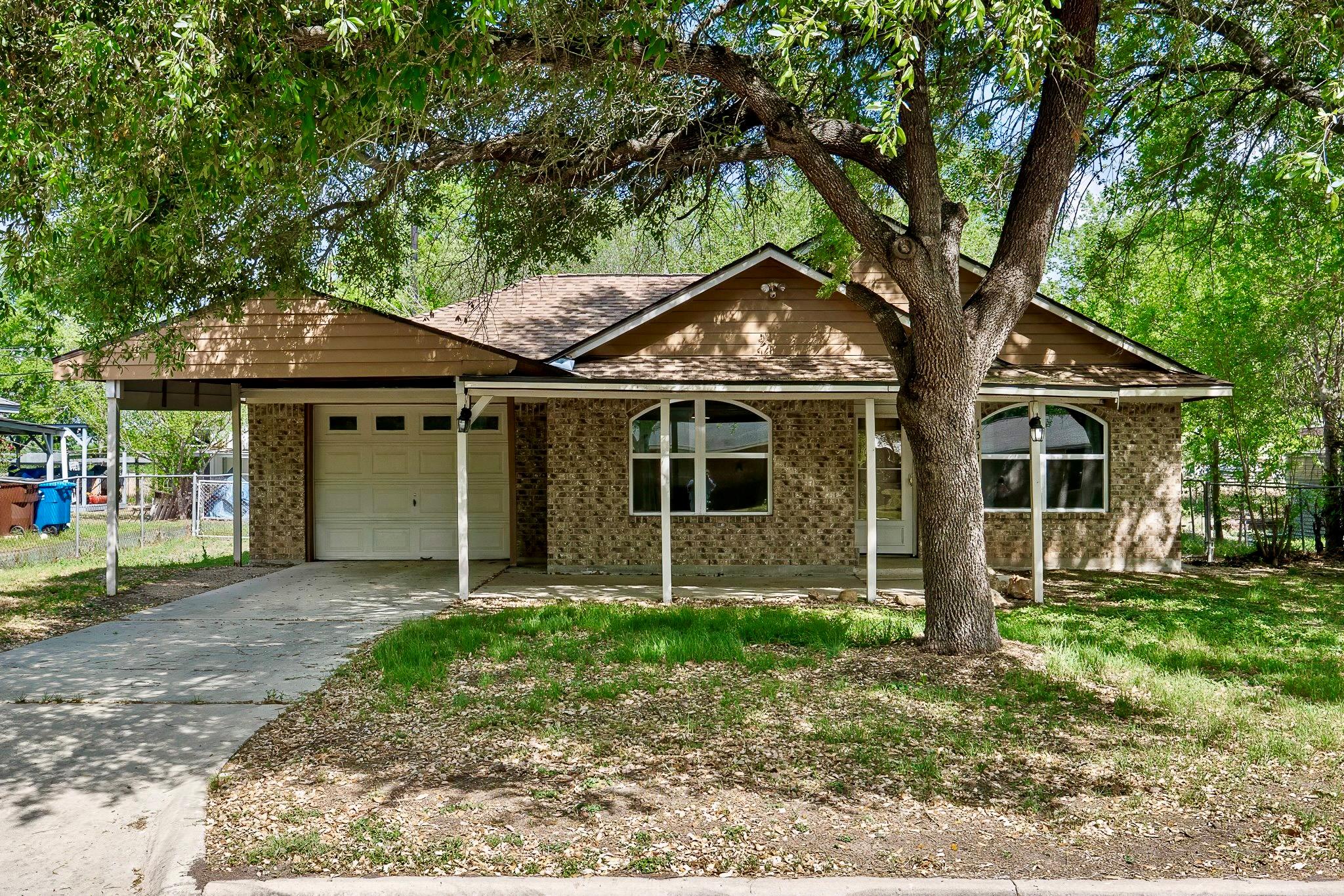 Ranch-style home with brick siding, a garage, and