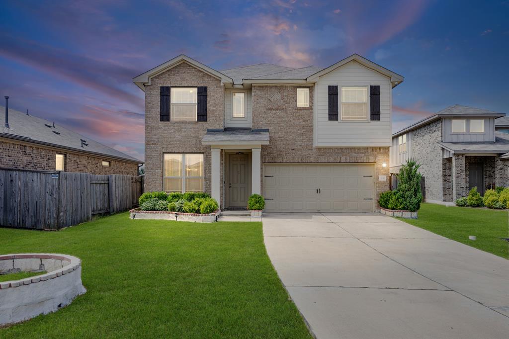 Traditional home with an attached garage, brick s