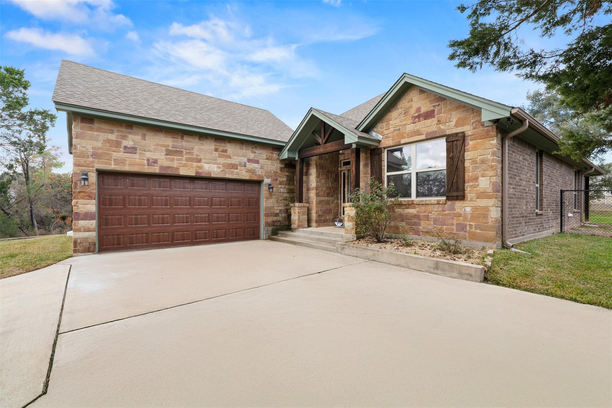 View of front of property featuring stone siding,