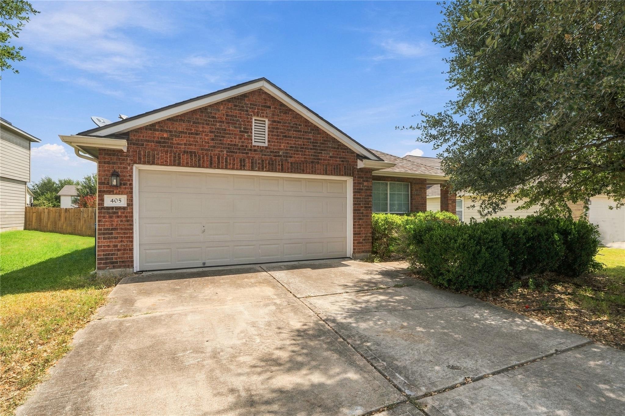 A classic brick exterior and a concrete driveway 