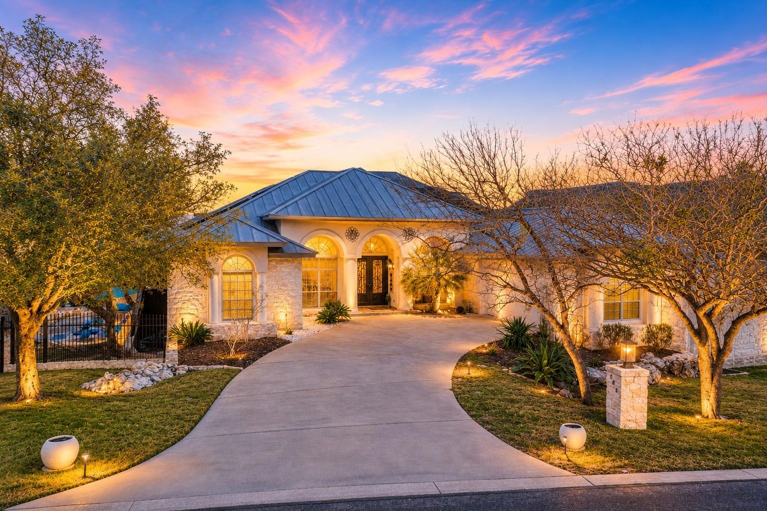 A graceful circular driveway leads to this archit