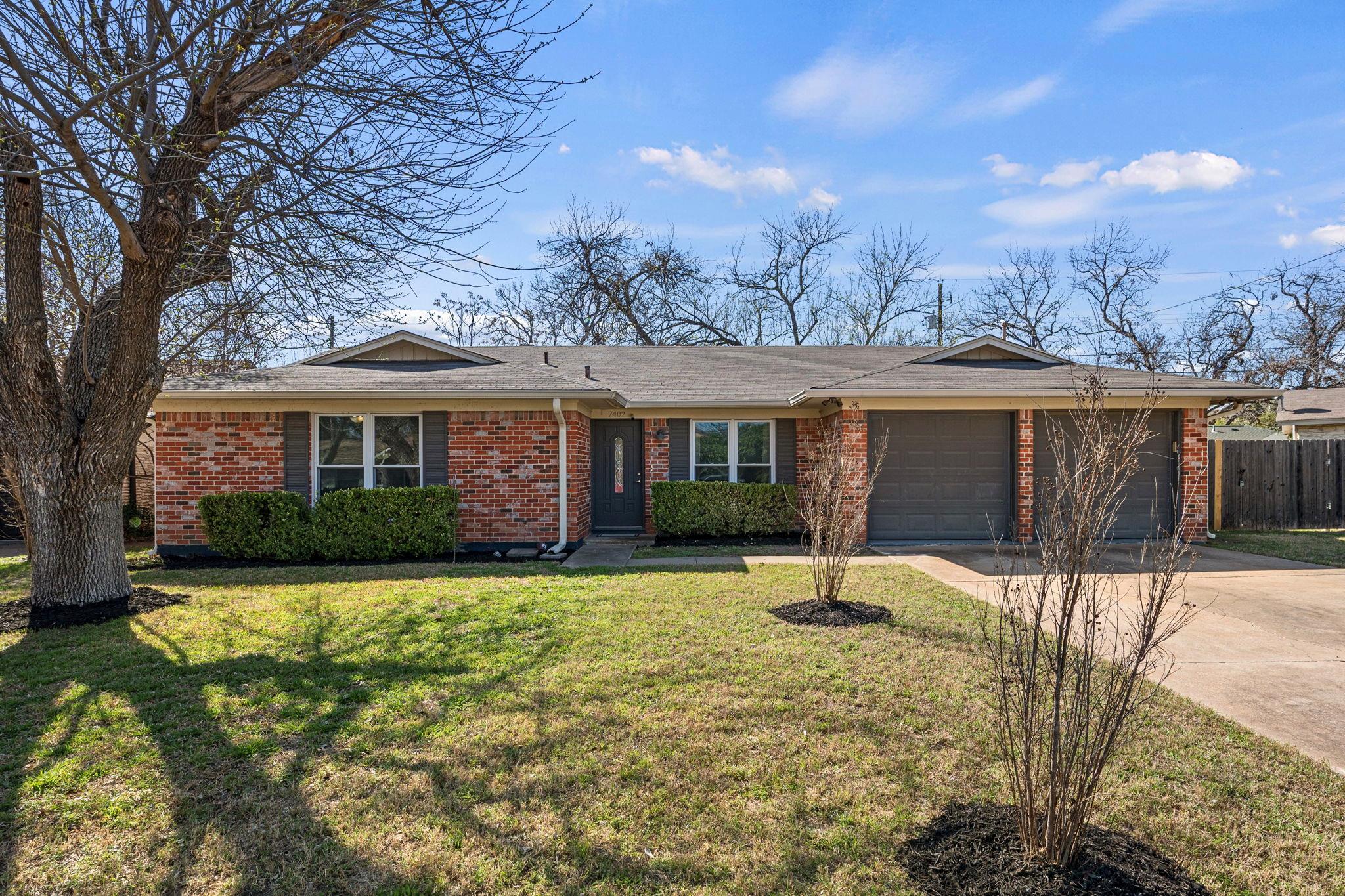Ranch-style house with an attached garage, drivew