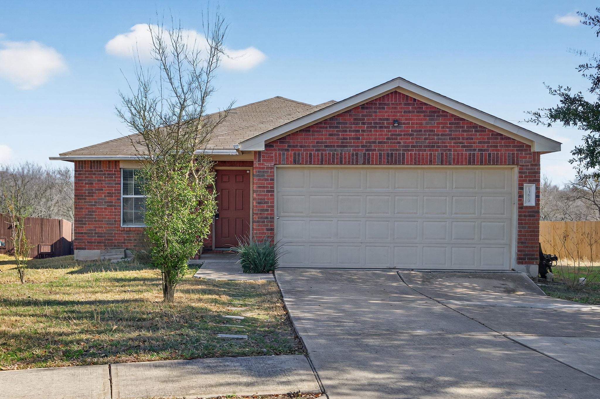 Ranch-style house with brick siding, an attached 