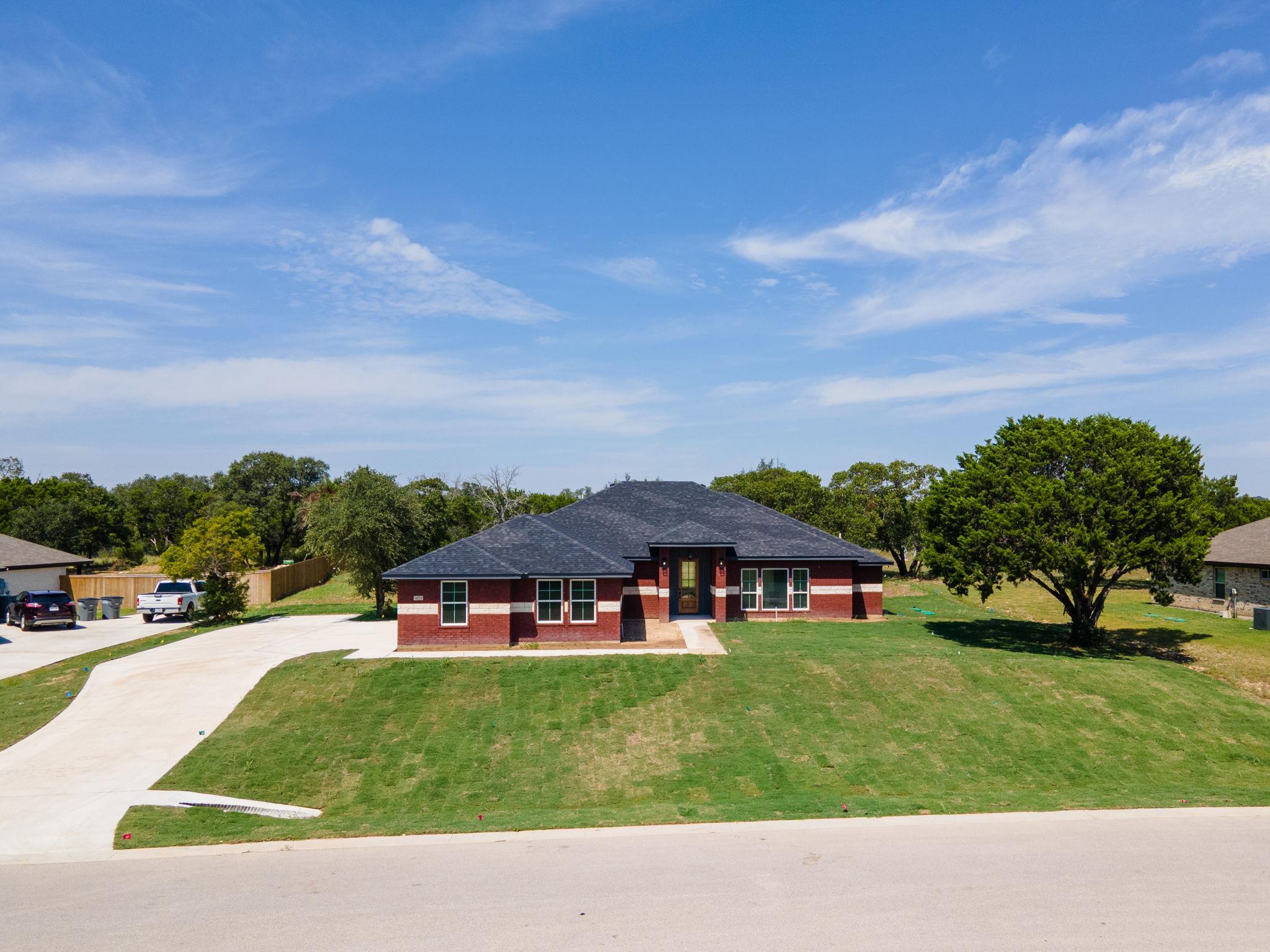 Prairie-style house featuring brick siding, drive