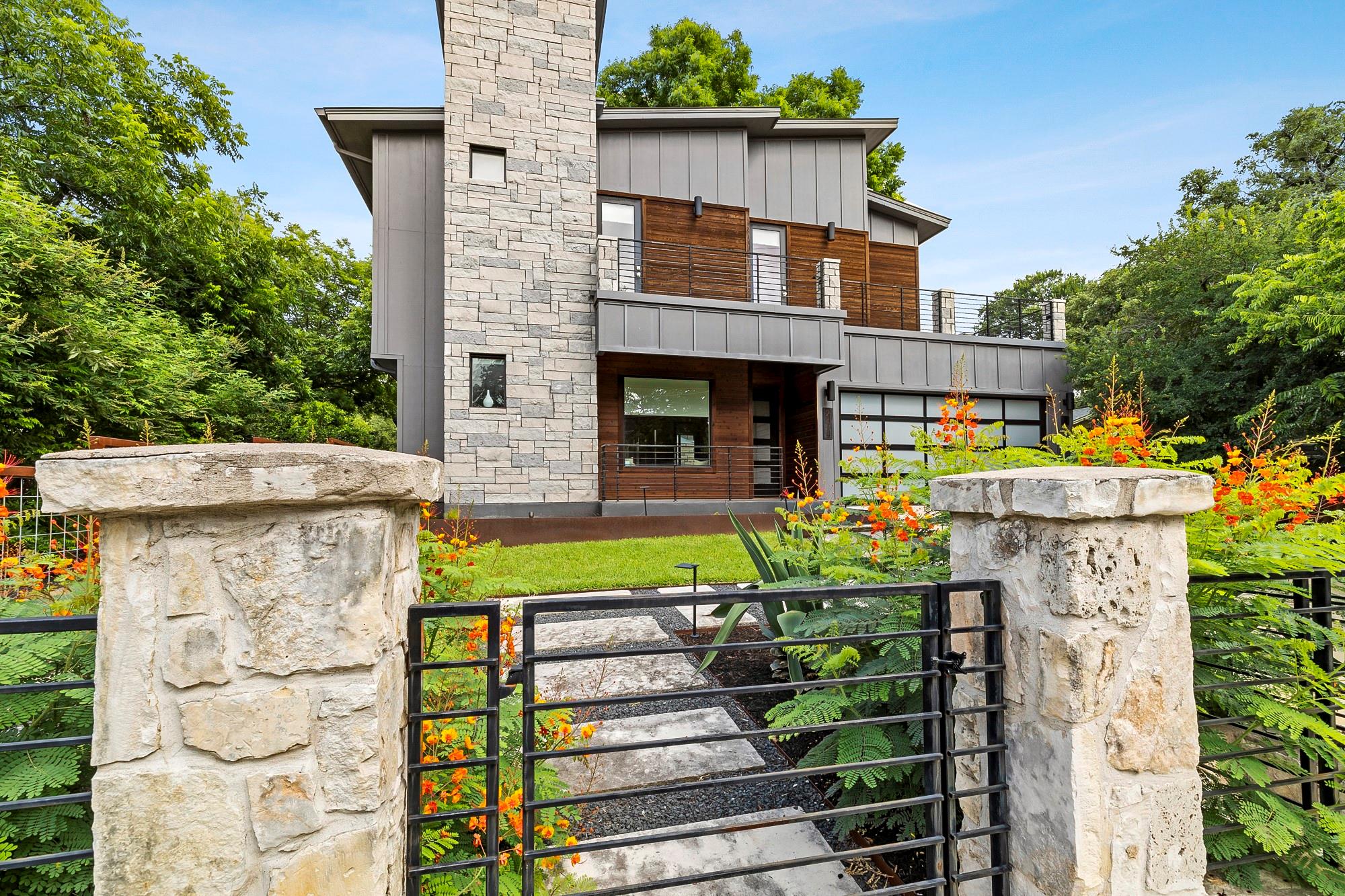 View of front of property featuring stone siding,