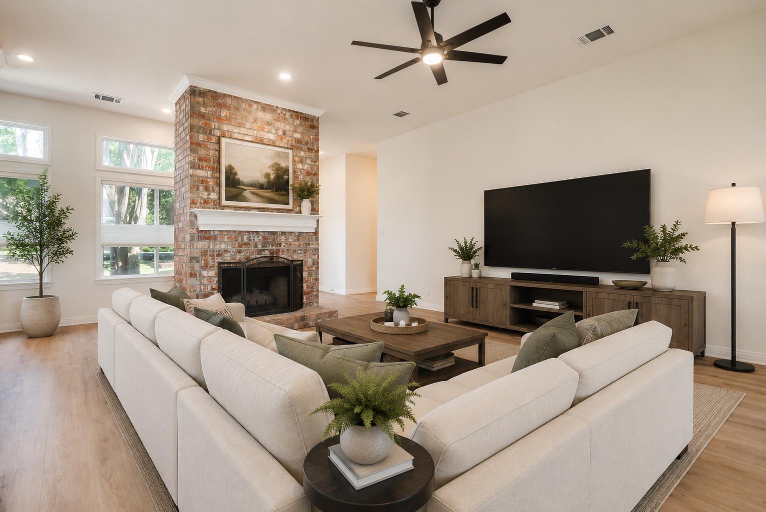 A spacious living room features a striking brick 