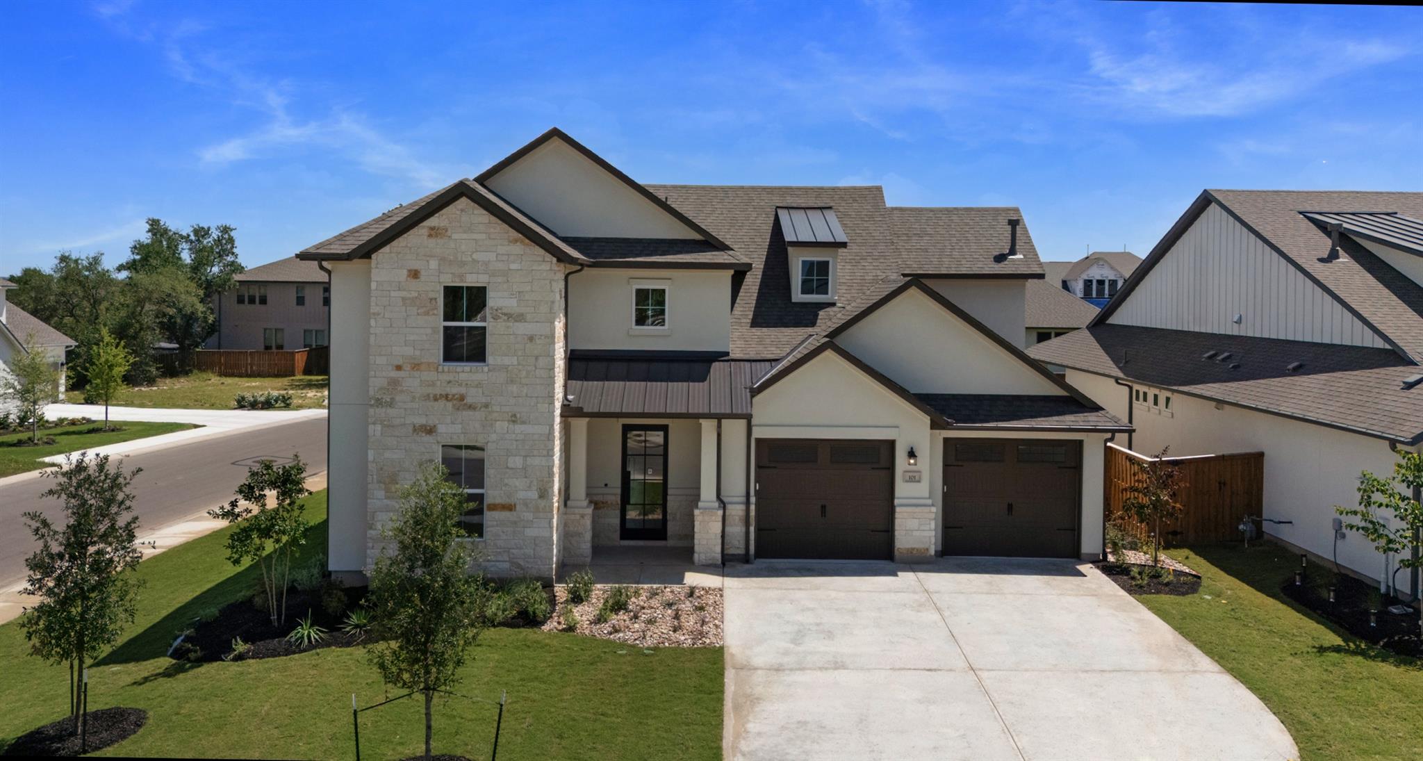Contemporary two-story residence featuring a ston