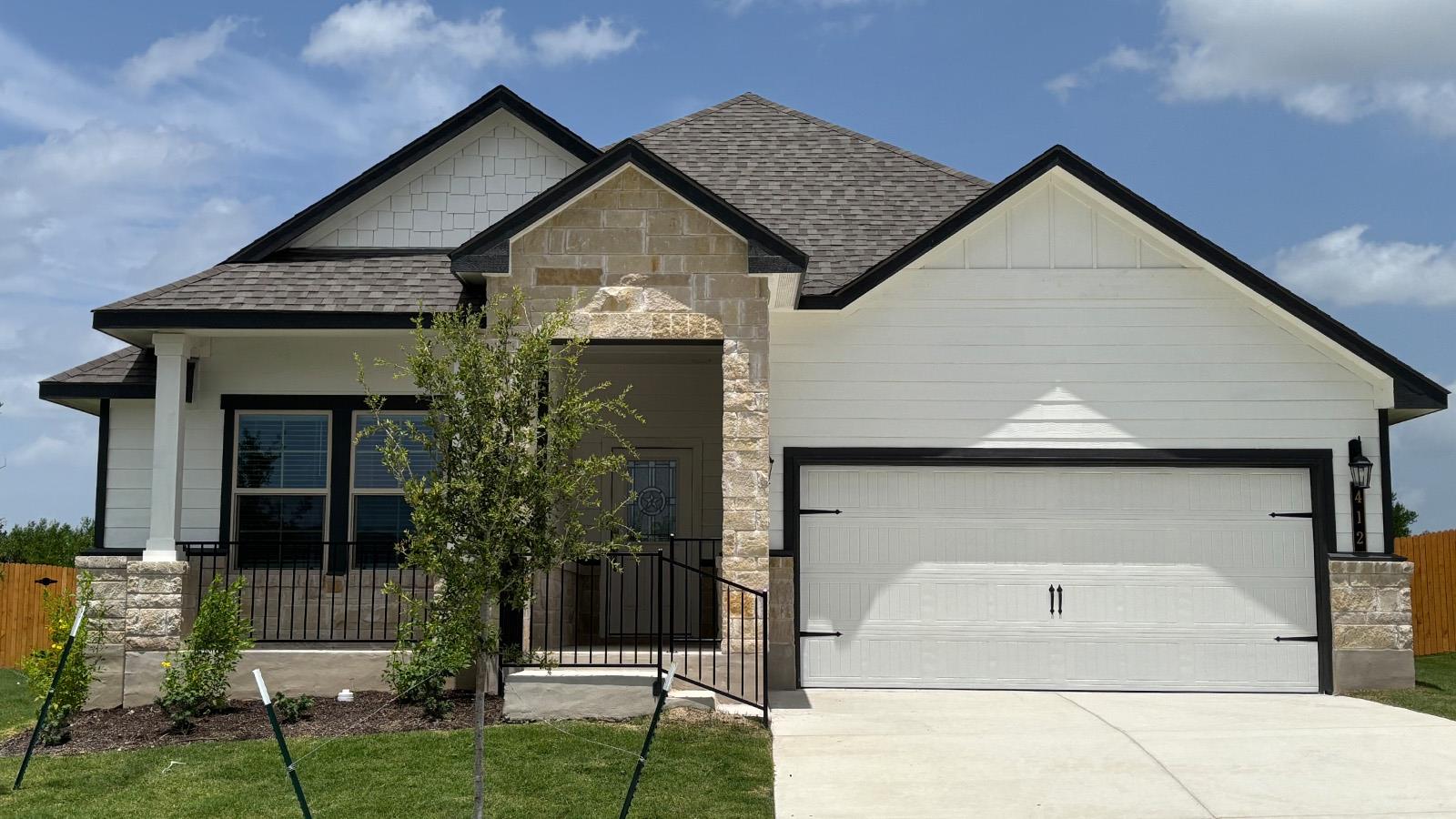 Clean lines and a striking stone entryway define 