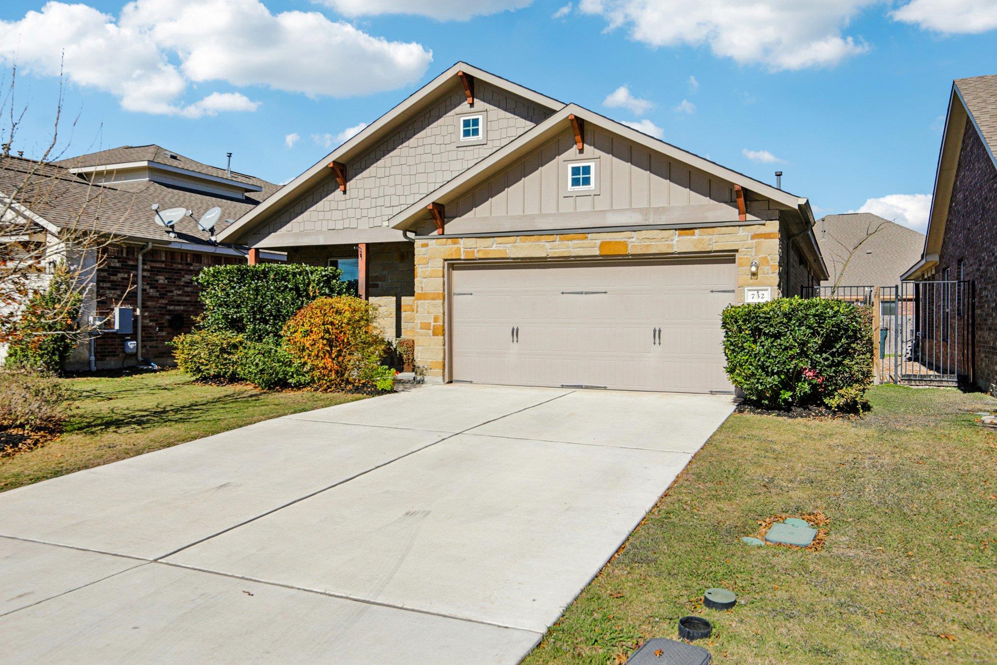 Craftsman inspired home with stone siding, concre