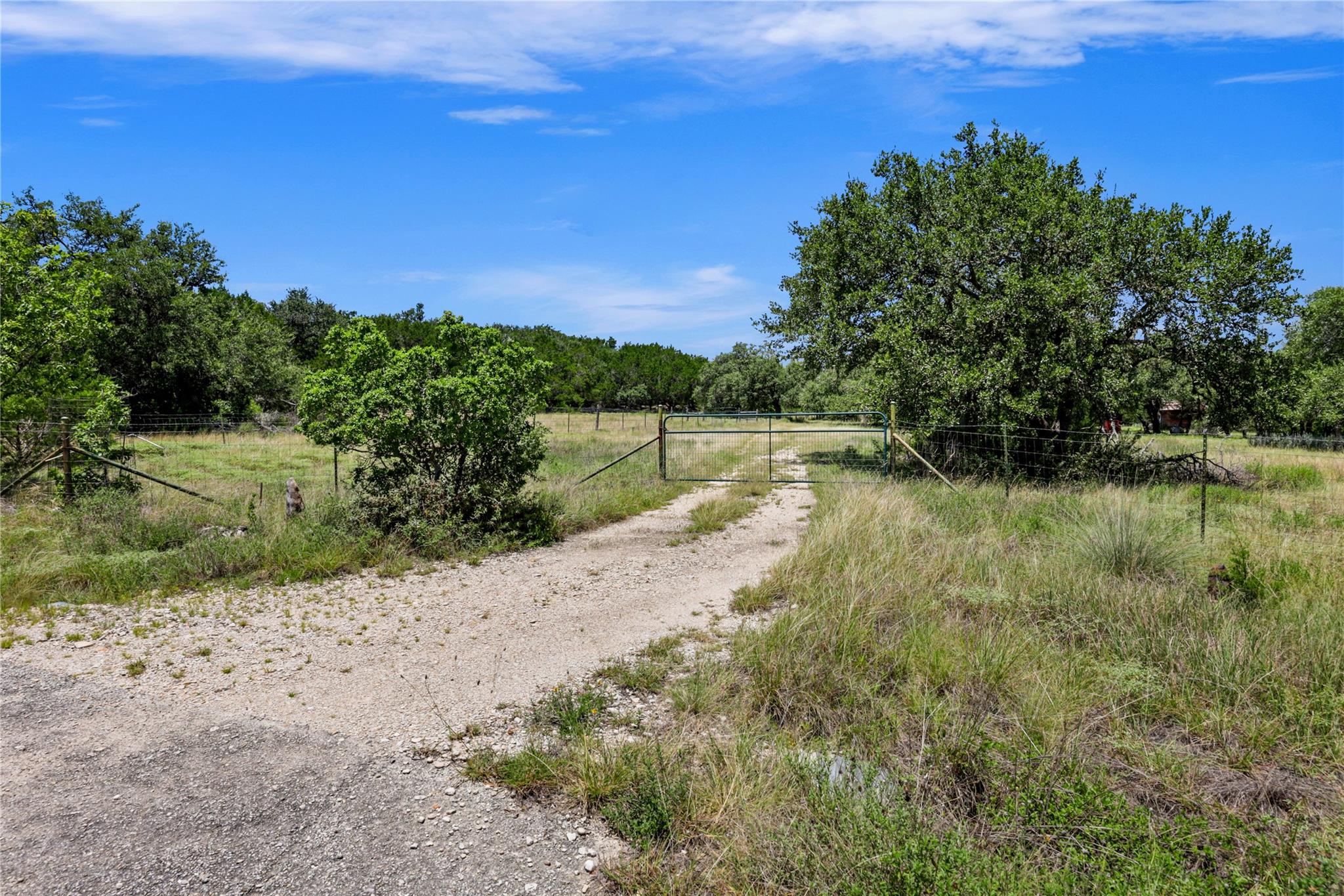 A private gravel drive leads to an expansive, ver