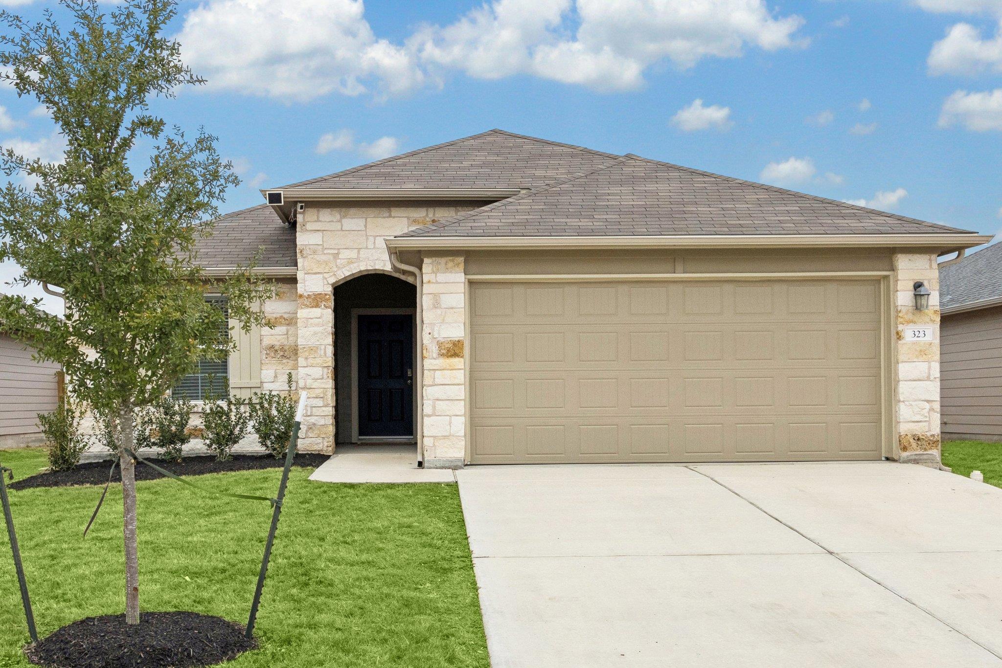 A neatly maintained lawn and welcoming stone faca