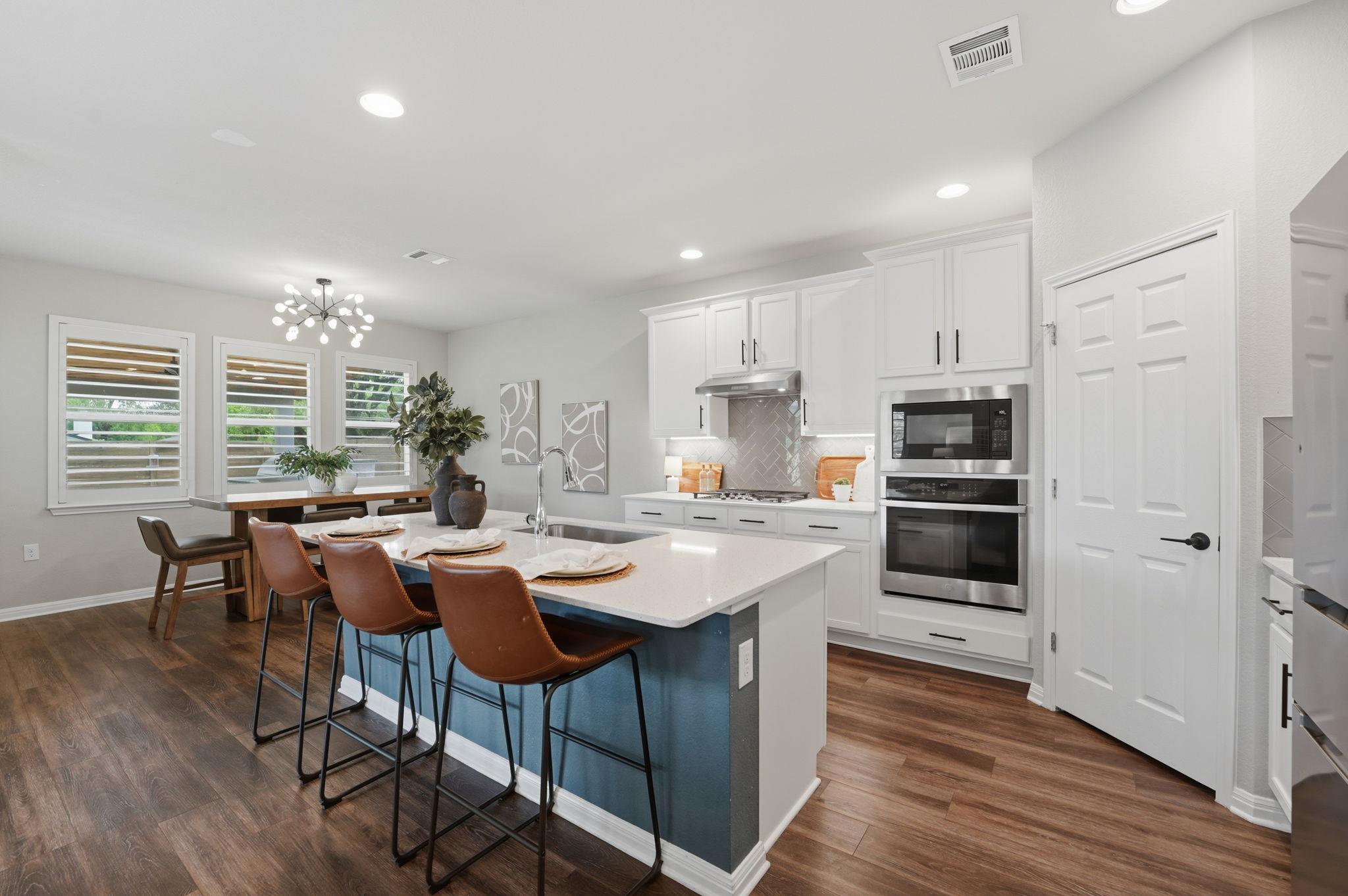 Open-concept kitchen featuring an island with cou