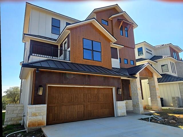 View of front facade featuring a standing seam ro