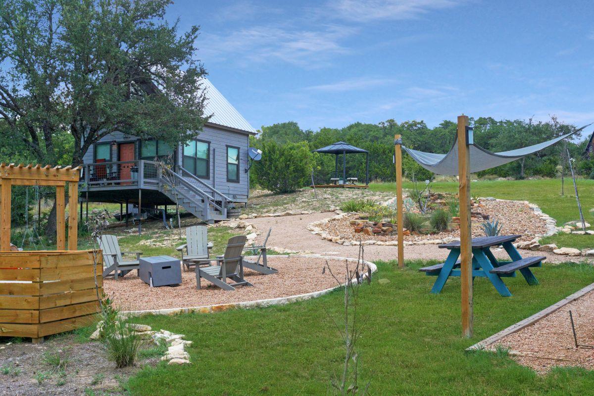 View of play area with a fire pit, a yard, a pati