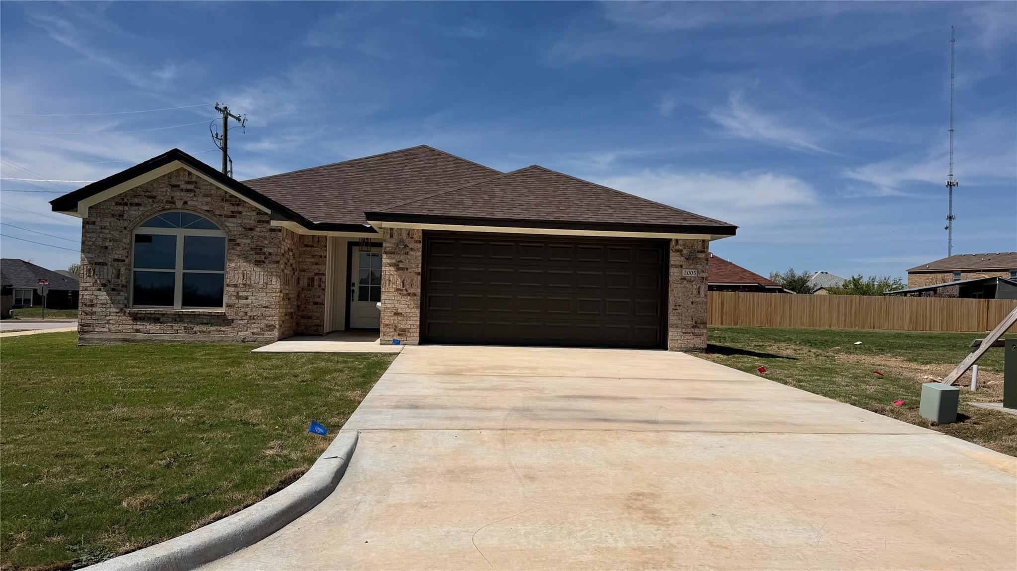 A newly constructed brick home with an attached g