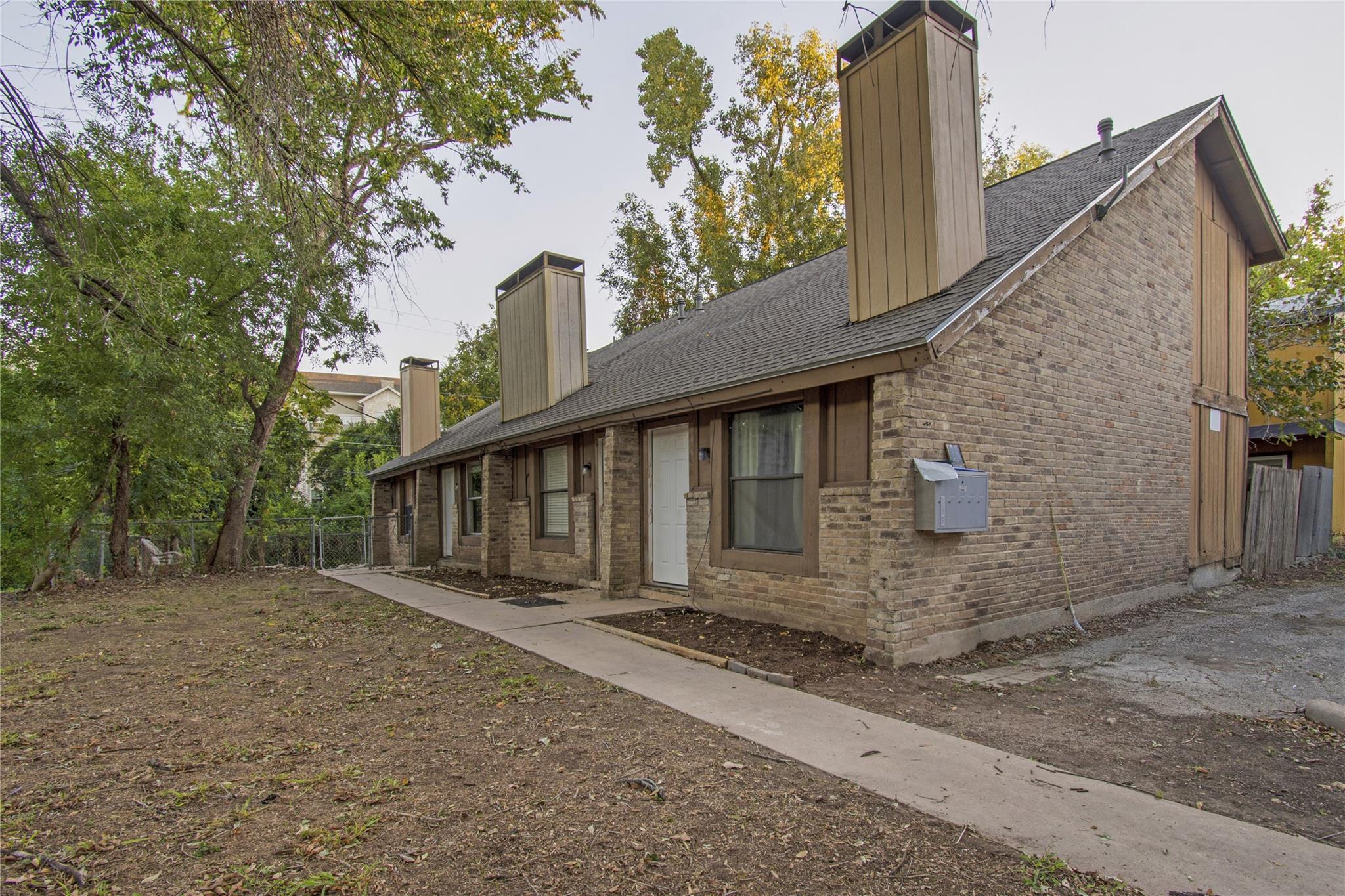 Rear view of house with a chimney, roof with shin