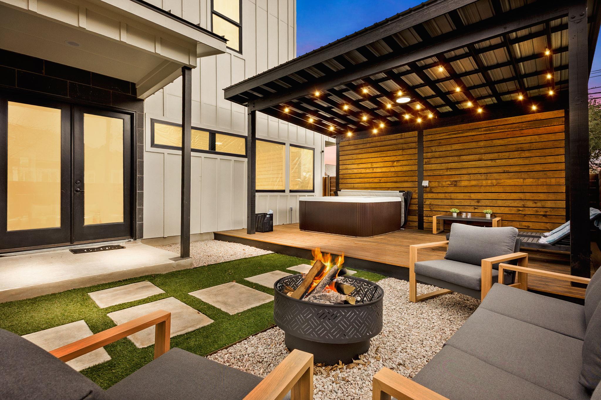 View of patio featuring a hot tub, an outdoor fir
