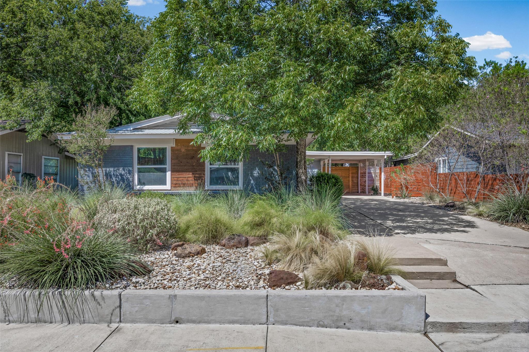 Mature trees and drought-tolerant landscaping fra