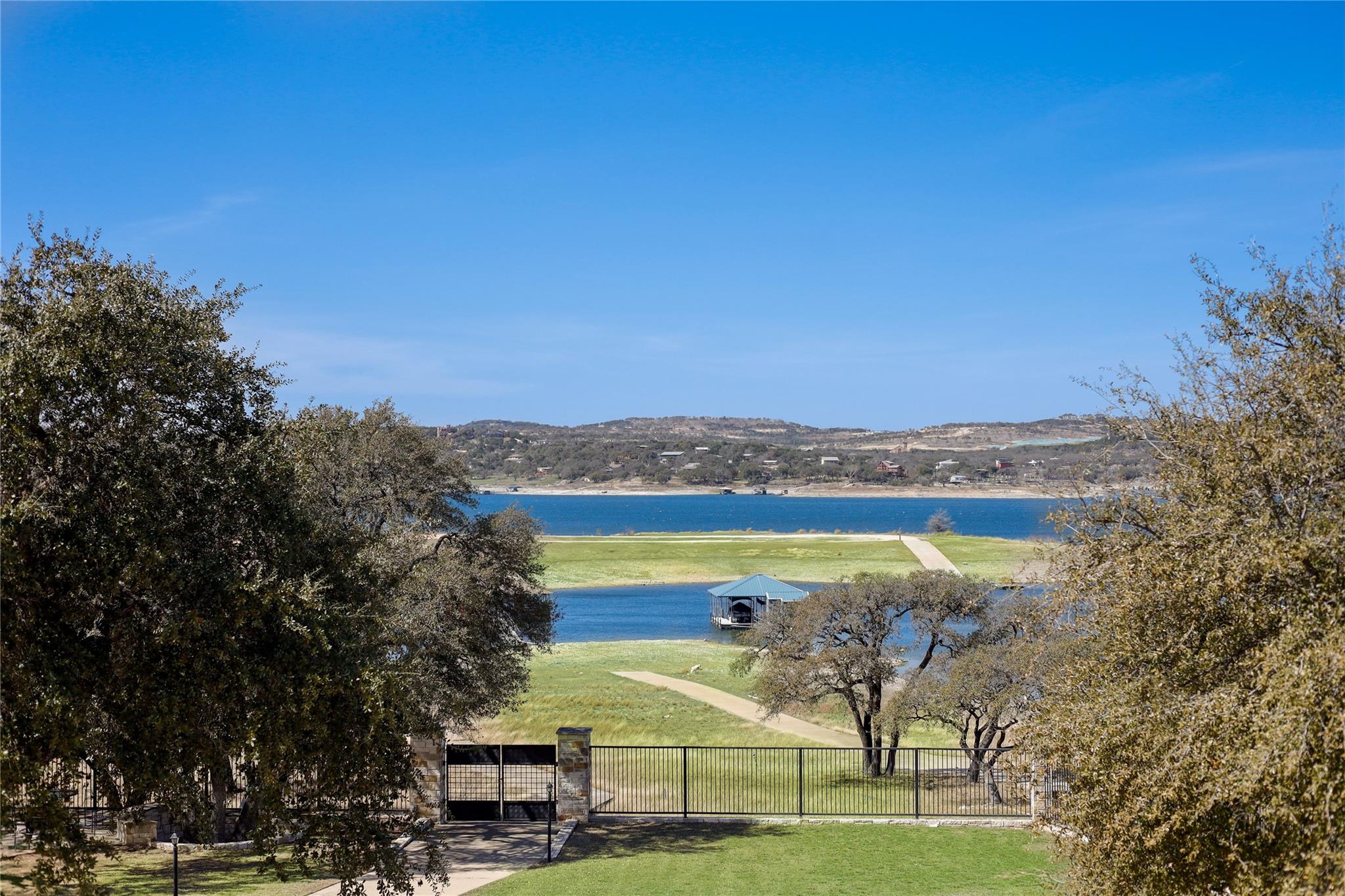 Water view with a fenced front yard and a gate