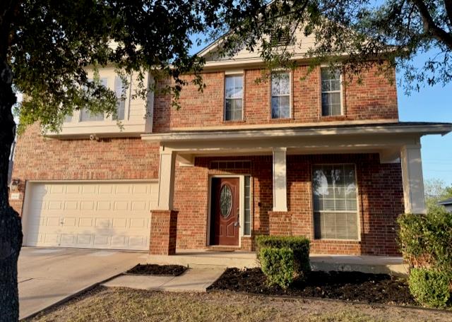 View of front of house with brick siding, a porch