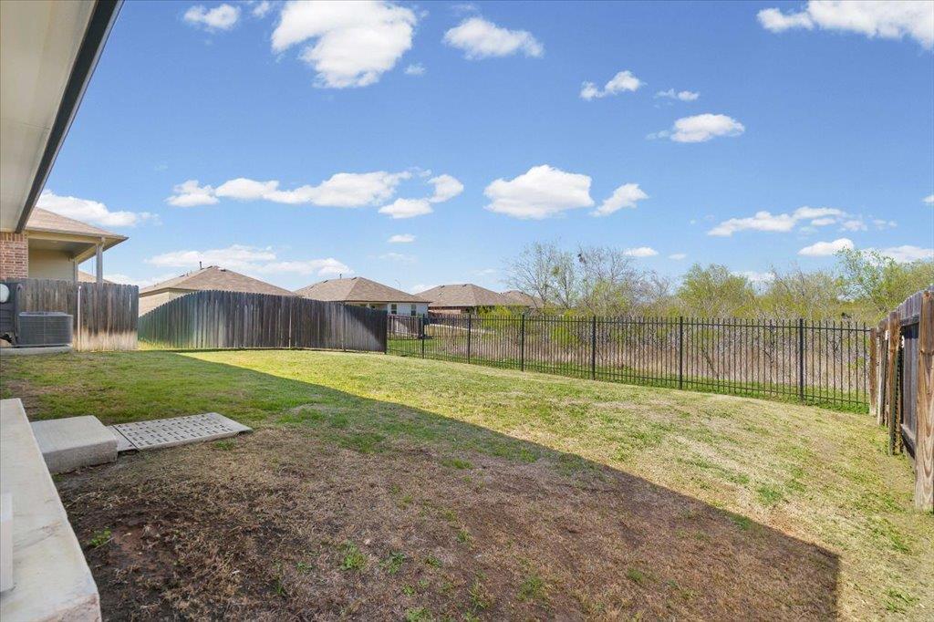 Fenced backyard featuring a patio