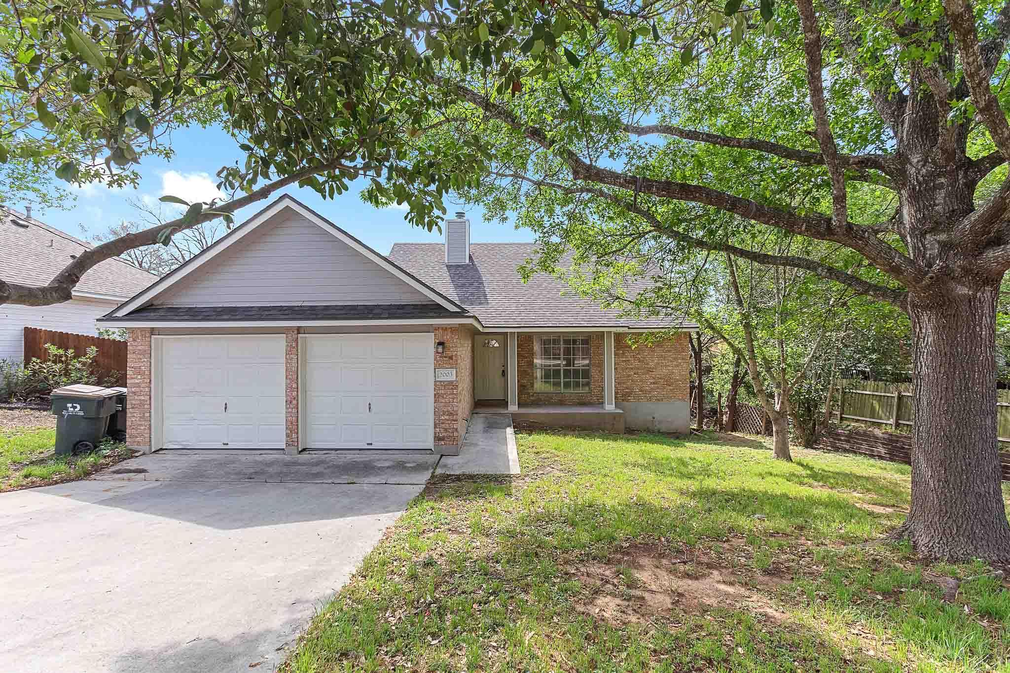 Single story home with a chimney, concrete drivew