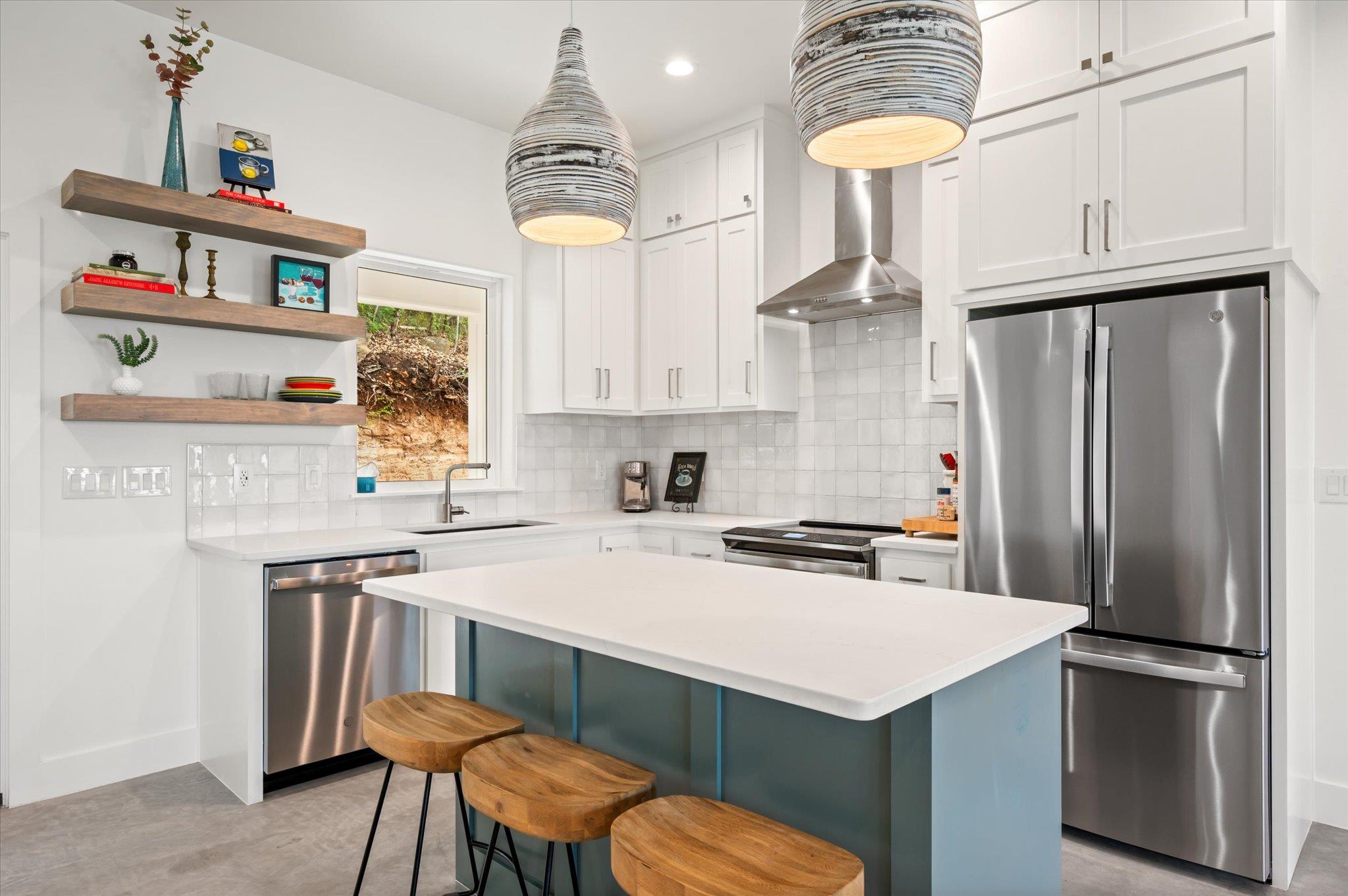 Kitchen featuring stainless steel appliances, two