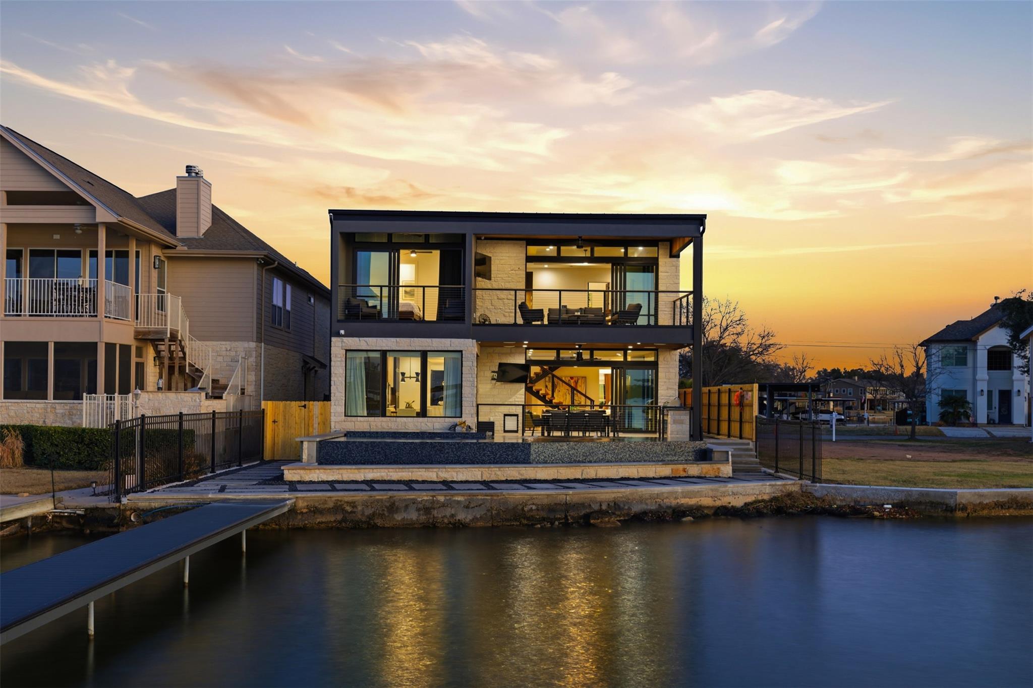 Rear view of property with a balcony, a patio, an