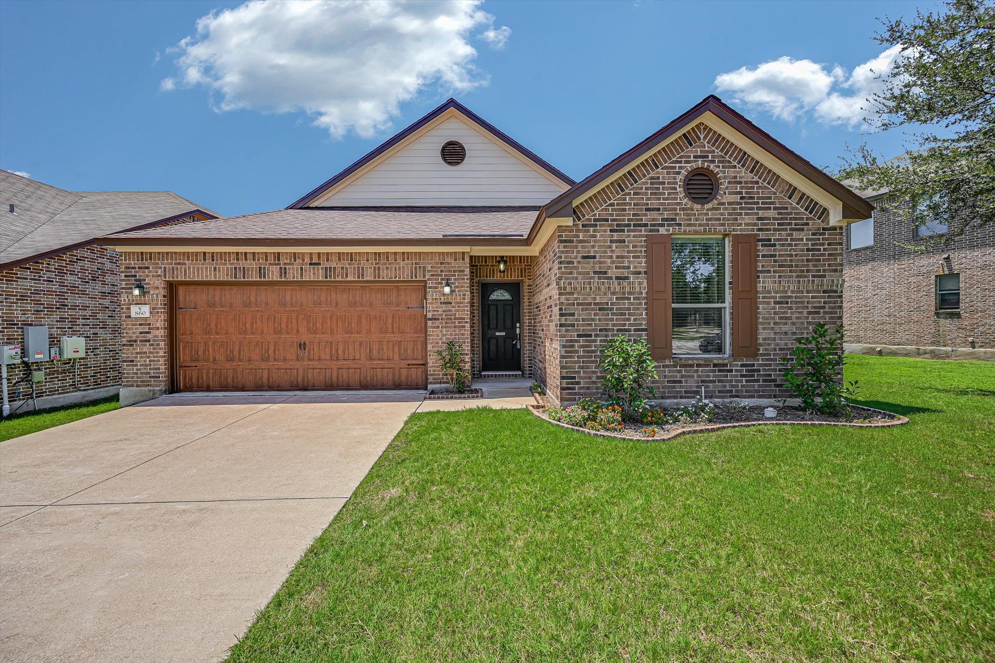 A classic brick facade welcomes with a charming w