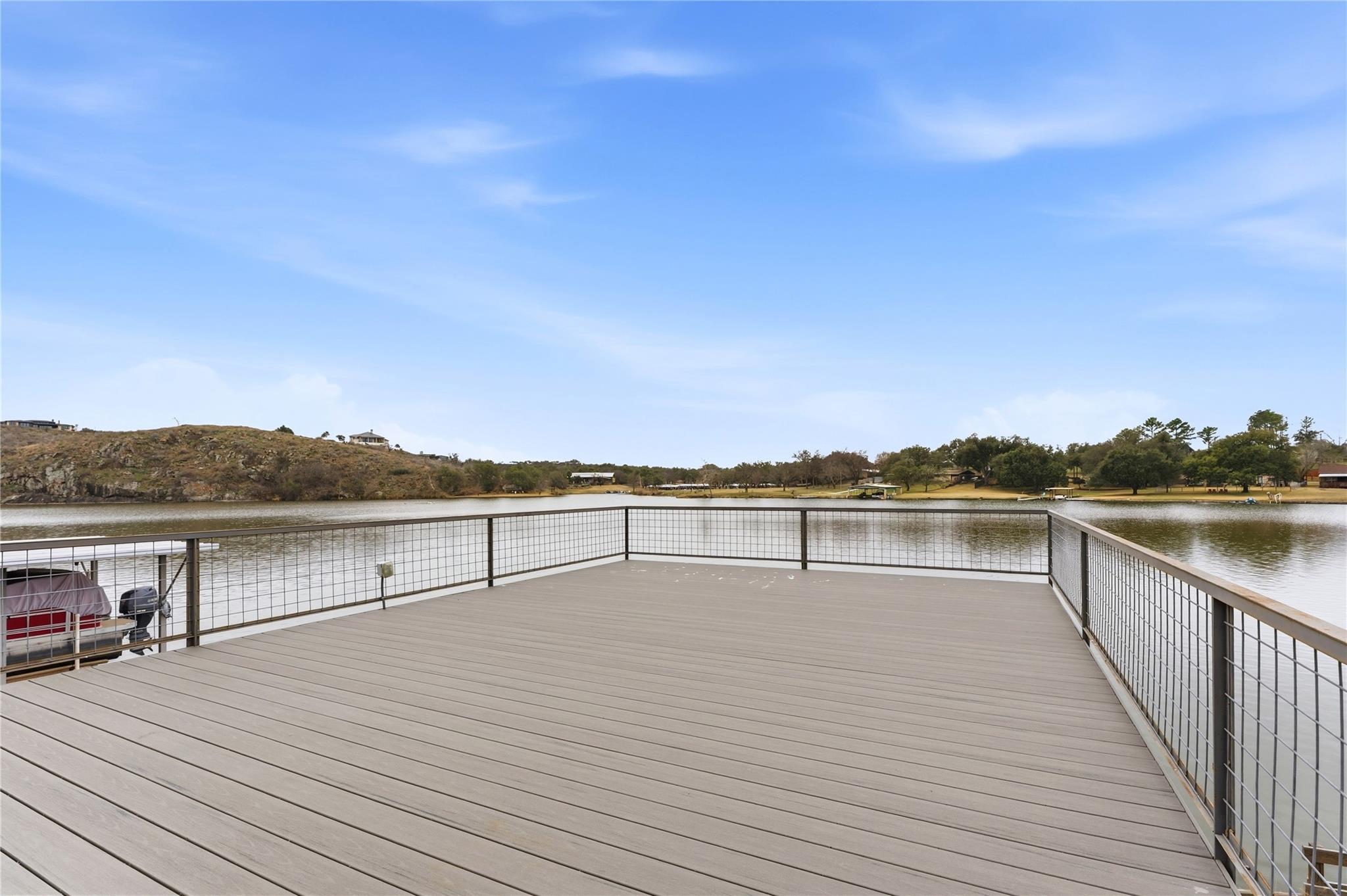 Dock area featuring a deck with water view